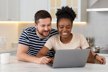 Canvas Print - International relationships. Lovely couple spending time together in kitchen