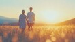 © tashechka - A senior couple walks hand in hand, basking in the warmth of the sun, amidst tall wildflowers on a serene evening