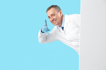 Poster - Mature doctor with blank poster showing 