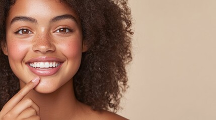 Wall Mural - This cheerful woman enjoys applying a light pink lip balm, her radiant smile and smooth lips capturing a fresh and natural look against a neutral beige background