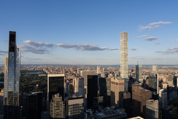 Aerial view of Manhattan skyline with skyscrapers and Central Park in the background on a clear day.