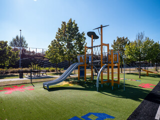 A beautiful children's playground on the parking area near the D1 highway near the town of Považská Bystrica in Slovakia. On the playground, children can have fun on climbing frames, swings and other.