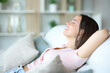 © Antonioguillem - Happy woman relaxing sitting in a comfortable sofa at home