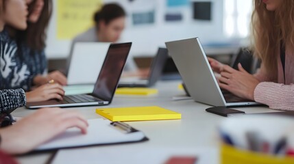 Poster - Three People Working at a Table with Laptops and Notebooks
