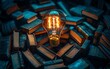 © Thanaseth - Concept image of ideas and knowledge featuring a glowing light bulb surrounded by a circle of books, symbolizing enlightenment and education