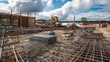 © Imsuniyah - Construction Site with Rebar, Excavators, and a Partially Constructed Building