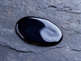 Wall Mural - Smooth black pebble on slate background