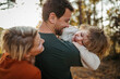 © Halfpoint - Parents and girl during walk in autumn forest. Girl having fun outdoors.