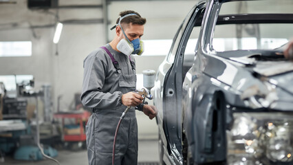 Workers painting cars