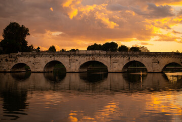 Discover the iconic Ponte di Tiberio, a Roman bridge spanning the River Marecchia in Rimini, Italy. Built in 20 AD, this majestic structure is a testament to Roman engineering and a must-see