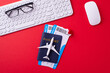 © ActionGP - A flat lay of travel essentials including a passport, boarding pass, and airplane model on a red workspace. Ideal for concepts of travel, vacation, and preparation