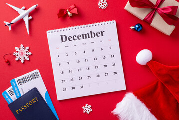 December calendar surrounded by travel and holiday items including a plane, passport, Santa hat, and gifts, symbolizing the festive season and vacation planning