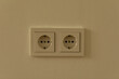 © vegefox.com - Two white electrical outlets on a beige wall