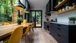 © familymedia - This stylish kitchen showcases dark cabinetry paired with striking yellow chairs and a wooden dining table, set against a backdrop of lush greenery.