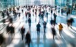 © FreyStudios - Long exposure shot of crowd of business people walking in bright office lobby fast moving with lot of blurry people, blue corporate background