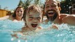 © familymedia - A family relishes a joyful moment in a bright pool under a sunny sky, encapsulating themes of happiness, togetherness, and carefree summer enjoyment.