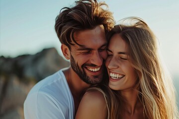 Portrait of happy young couple in love hugging on the beach.