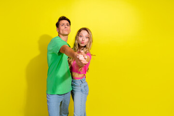 photo of two nice young people hold arms dance empty space wear t-shirt isolated on bright yellow co