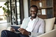 © Rawpixel.com - Business black man sitting and holding tablet computer smiling adult.