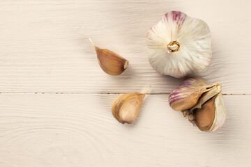 Fresh Garlic Cloves and Bulb on Light Wooden Surface: Culinary Spice and Healthy Ingredient