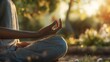 © saefurridhoalghoza - A close-up of a person meditating in a peaceful outdoor setting..