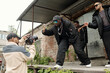 © pressmaster - Group of African American men performing outdoors for music video captured by videographer