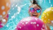 © pisan thailand - young woman with colorful sunglasses laughing and having fun in a swimming pool surrounded by inflatable toys and splashing water  Vibrant playful and full of energy capturing