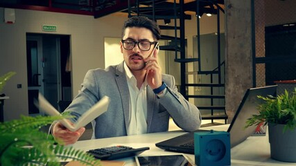 Poster - professional man working intently in a modern office setting during the day