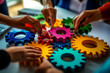 © Edgar Martirosyan - A group of people holding colorful gears in their hands, a collaboration and success concept.