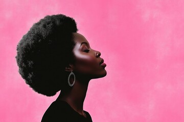 Poster - A woman with an afro hairstyle stands in front of a bright pink background, ideal for use in diversity and inclusion campaigns or fashion photography.