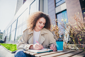 Wall Mural - Photo of lovely cute positive lady enjoying sunny warm september weather outdoors sitting on cafe terrace