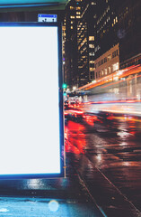 Wall Mural - Bus station billboard in rainy night with blank copy space screen for advertising or promotional content, empty mock up Lightbox for information, blank display in urban city street with long exposure