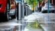 © svastix - A line of reflective bollards stand on a wet urban sidewalk, capturing a sense of safety and order amid the hustle of city life, reflecting modern urban design.