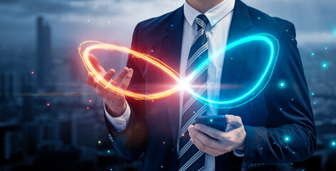 Leinwandbilder - Businessman using mobile phone with infinity symbol connecting unlimited internet data usage 5G technology , limitless infinite data user storage cloud computing network security, city blue background