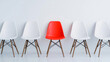 © Piya W. - Highlighted red chair in the middle of a row of white chairs on white background Illustration of the concept of right candidate in job interviews