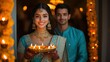 © Art Resources - Portrait of a young Indian woman in a bright turquoise lehenga with silver accents and a young Indian man in a matching turquoise kurta, both holding a single big thali with diyas, standing