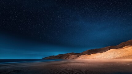 Wall Mural - Nighttime beach scene with a star-filled sky, calm ocean waves, and illuminated sand dunes along the shoreline