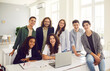 © Studio Romantic - Portrait of a diverse group of happy multinational teenage students during lesson with teacher in a school classroom. Learning reflecting the positive interaction between the students and teacher.