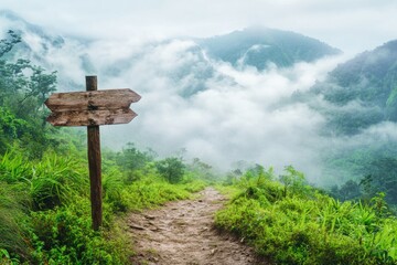 Poster - A wooden sign on a dirt path in the mountains, ideal for outdoor adventure or nature-themed designs.