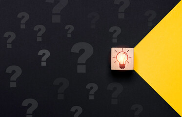 Poster - Glowing lightbulb on wooden block cube move yellow to black side with question mark for problem solving solution and curative thinking idea innovation concept.