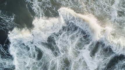Wall Mural - aerial view of crashing ocean waves creating dynamic patterns.