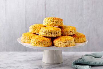 Wall Mural - Scones, traditional British bakery on cake stand. Grey background. Close up.