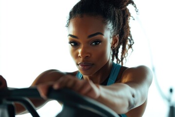 Poster - A woman works out on a stationary bike in a modern gym setting, perfect for fitness and exercise imagery.