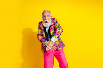 Wall Mural - Photo portrait of attractive retired man have fun disco dressed stylish colorful pink fancy clothes isolated on yellow color background