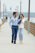 © auremar - romantic couple walking on a pier
