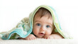 © limoncello - A cute baby lying on the carpet, looking at the camera. covered with a blanket.