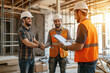 © WETDREAM - Three men are shaking hands in a construction site