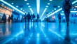 © DJSPIDA FOTO - A dynamic urban scene depicting blurred silhouettes of people moving through a modern, illuminated space, emphasizing motion and busy life.