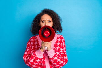 Poster - Photo of american beautiful girl with curly hair wearing red stylish cardigan hold megaphone angry activist isolated on blue color background