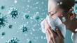 © lisbeth - Young woman sneezing, coughing, and blowing her nose during cold and flu season highlighting health and illness concepts